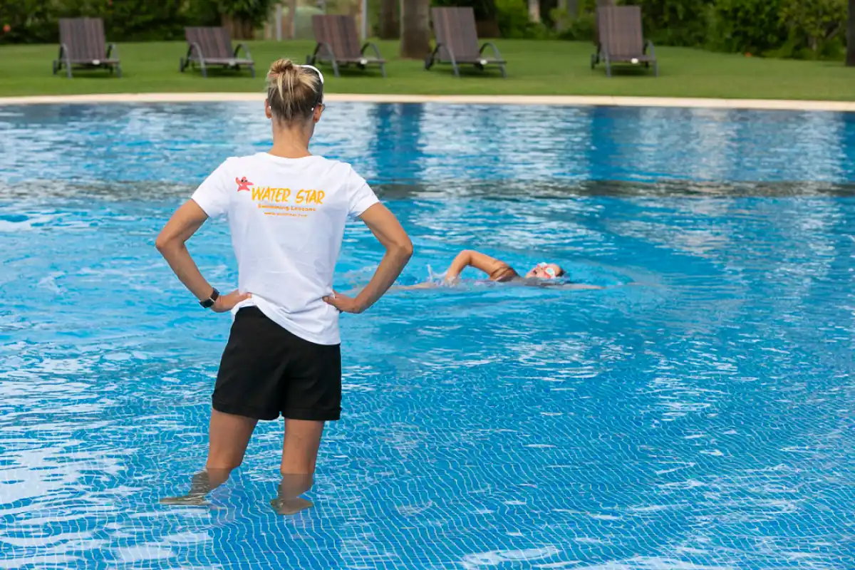 Swimming teacher giving lessons to children in Marbella
